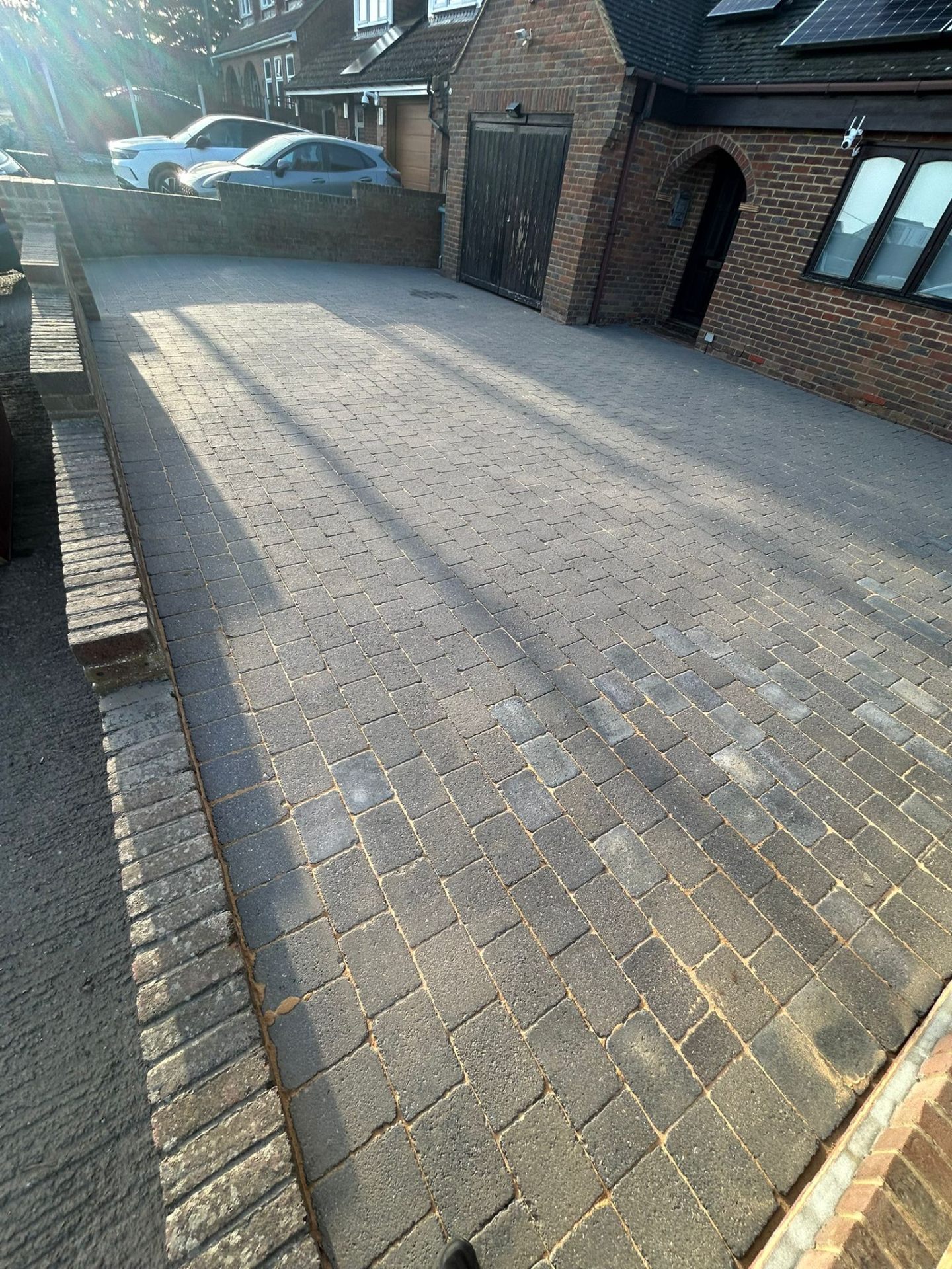 Full driveway view after professional cleaning showing restored block paving