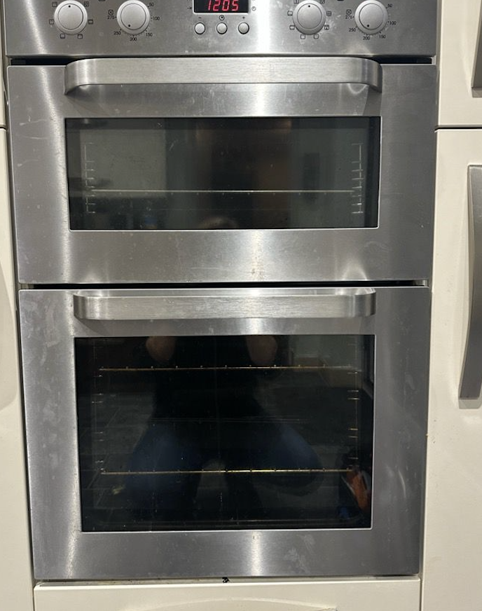 Double oven before professional cleaning - showing dirty glass and grime buildup