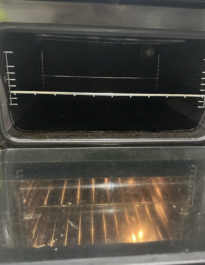 Oven interior before cleaning - showing grease and carbon buildup