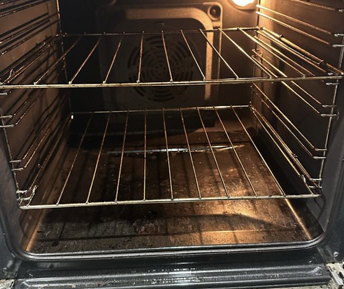 Oven interior before cleaning - dirty racks and base