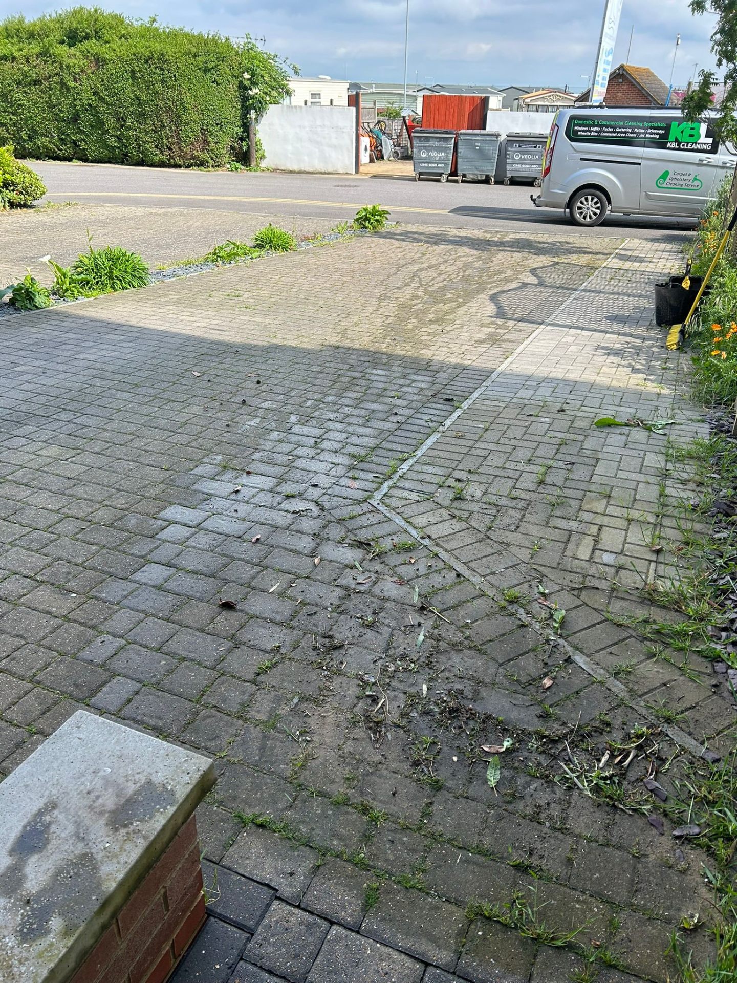 Before - Driveway with weeds and dirt buildup