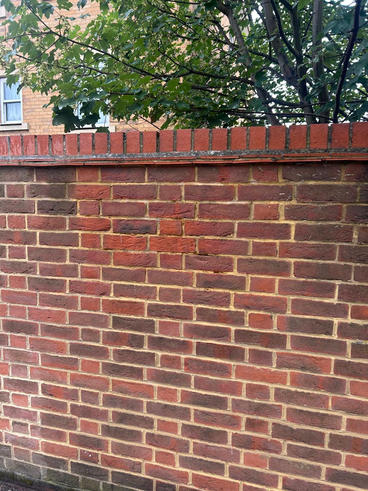 Before - Spray paint graffiti on red brick wall