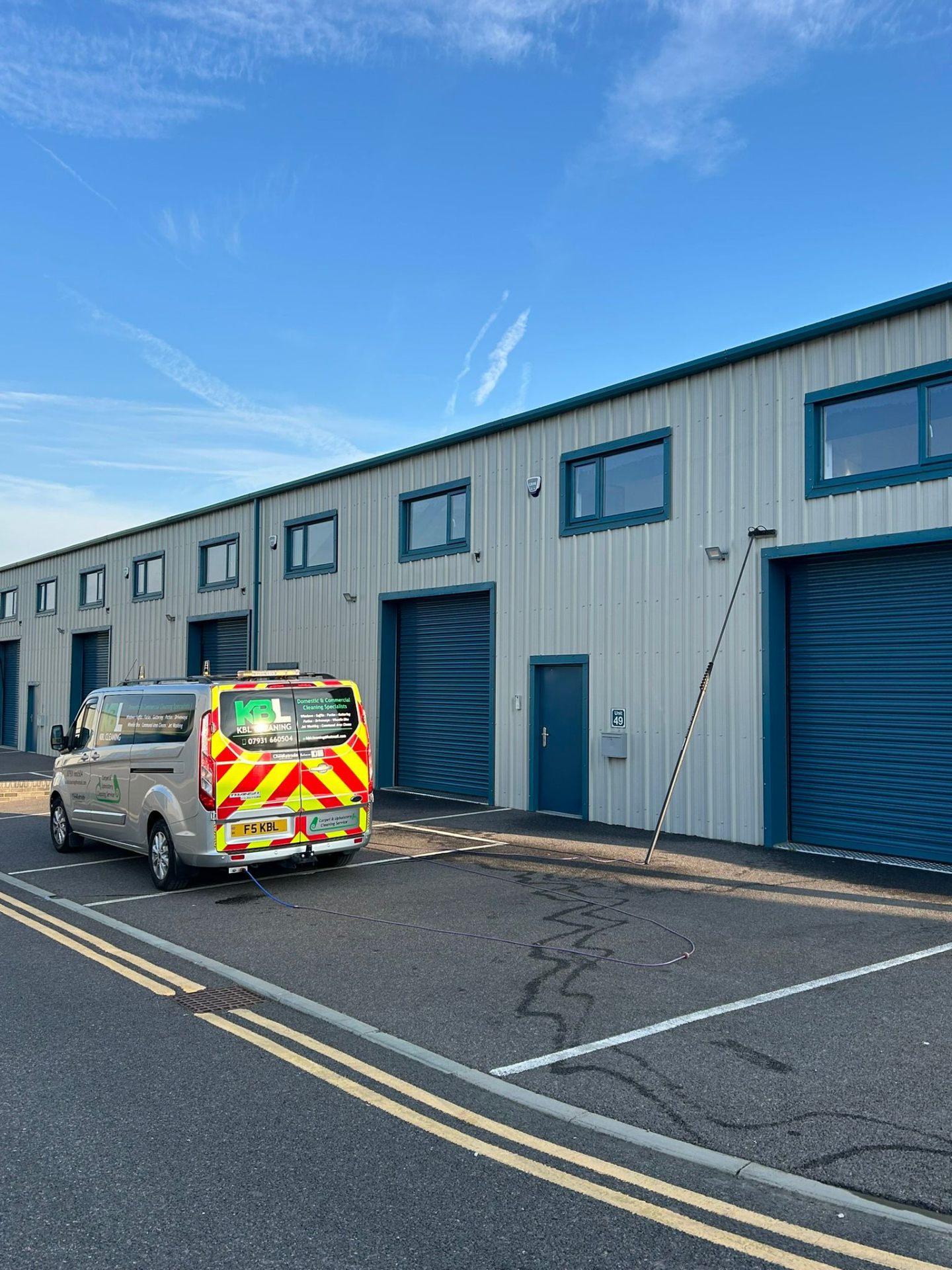 KBL Cleaning van at industrial building window cleaning service