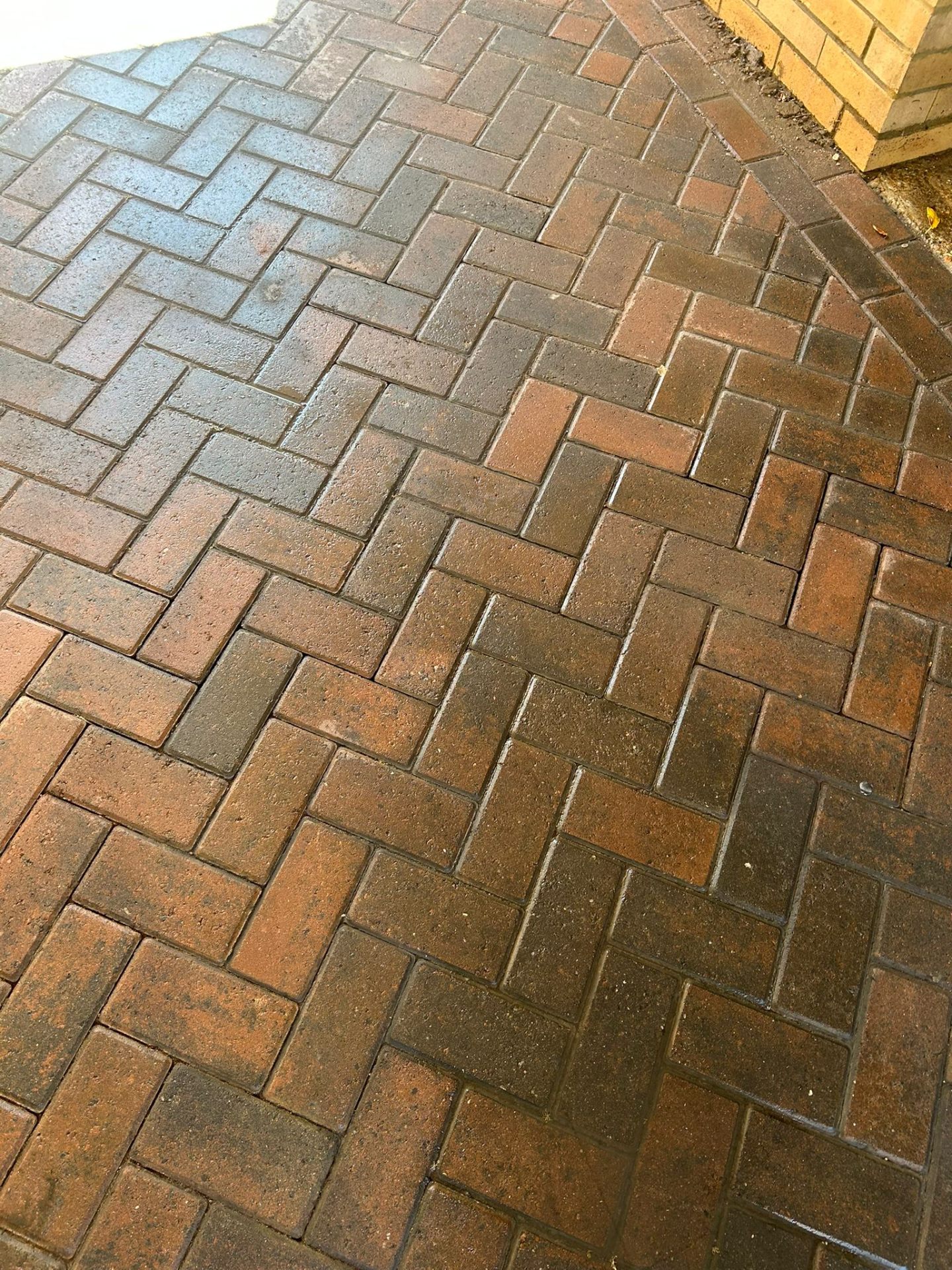 Block paving driveway before cleaning showing moss and staining