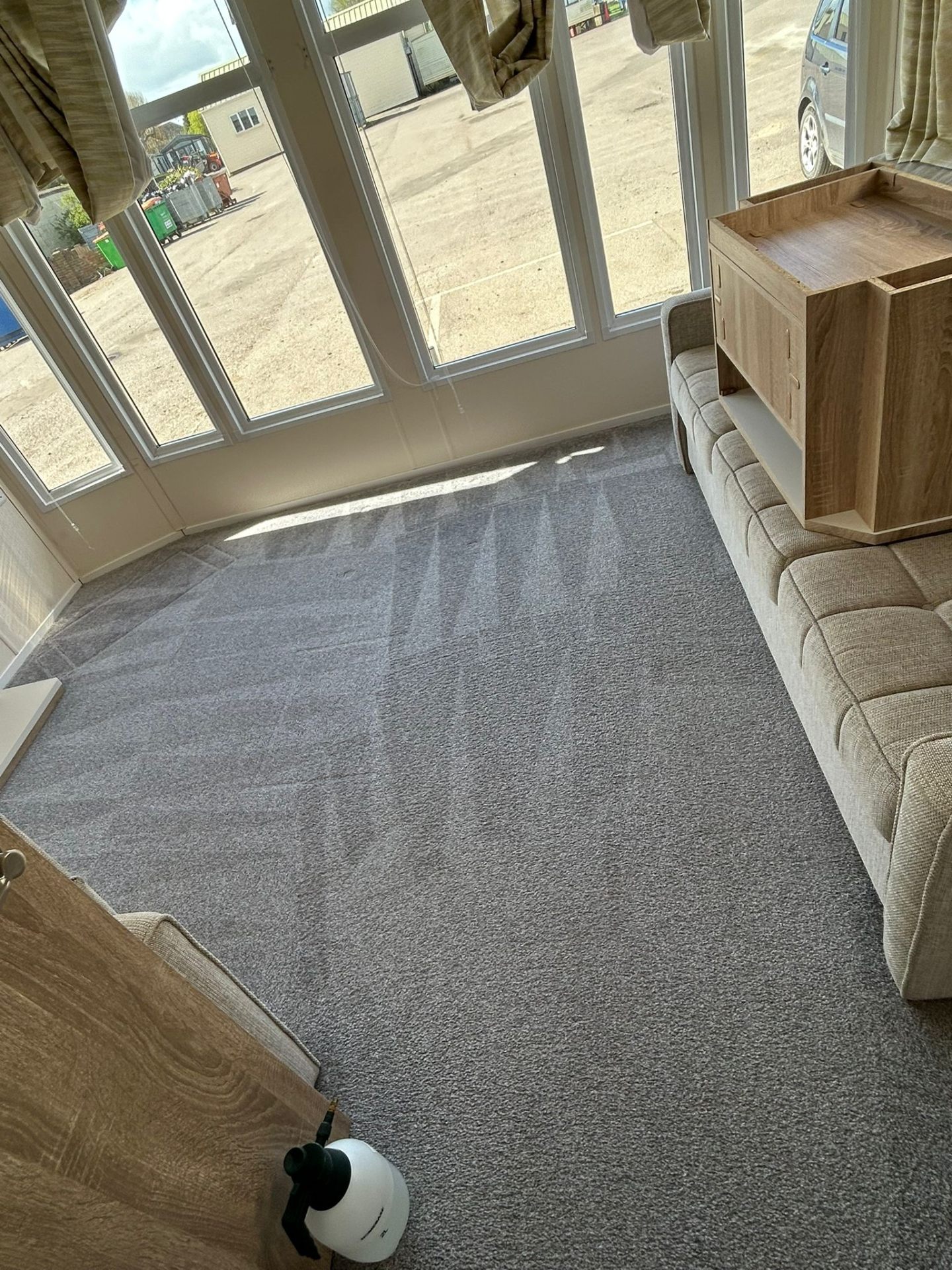 Clean grey carpet in modern living room with furniture