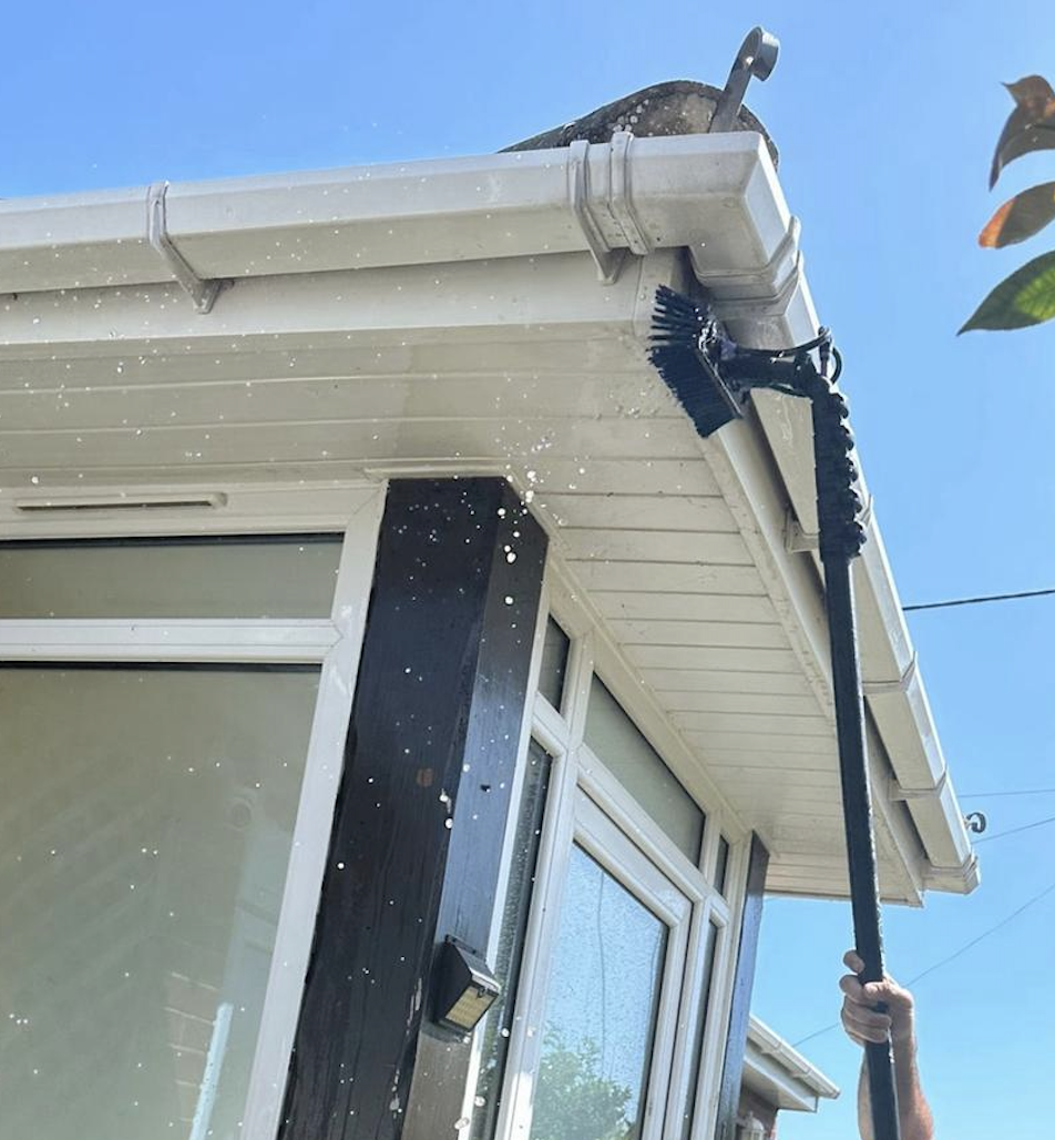 Professional gutter cleaning service being performed on residential property