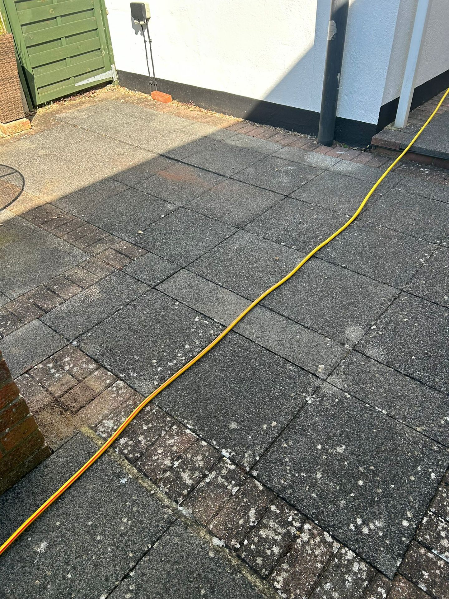 Before - Patio area with heavy staining and deteriorated pointing