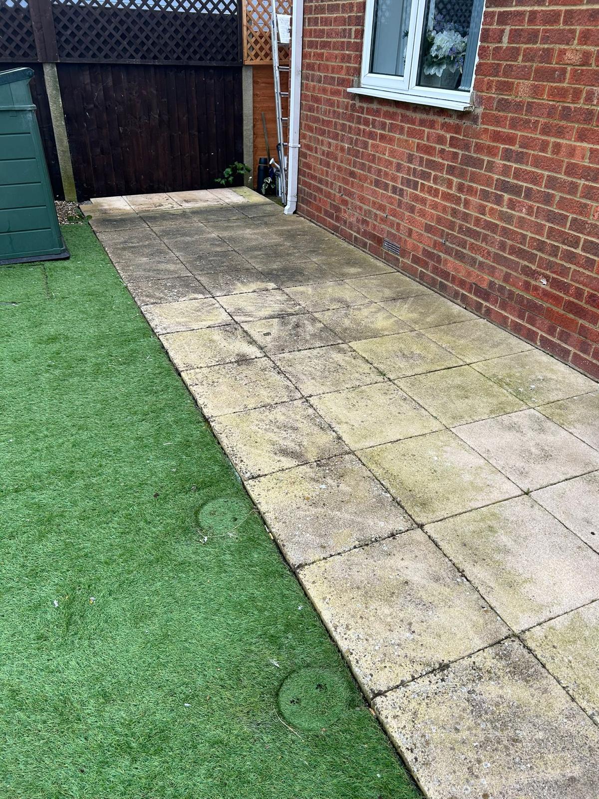 Before - Dirty patio slabs with staining and dirt buildup