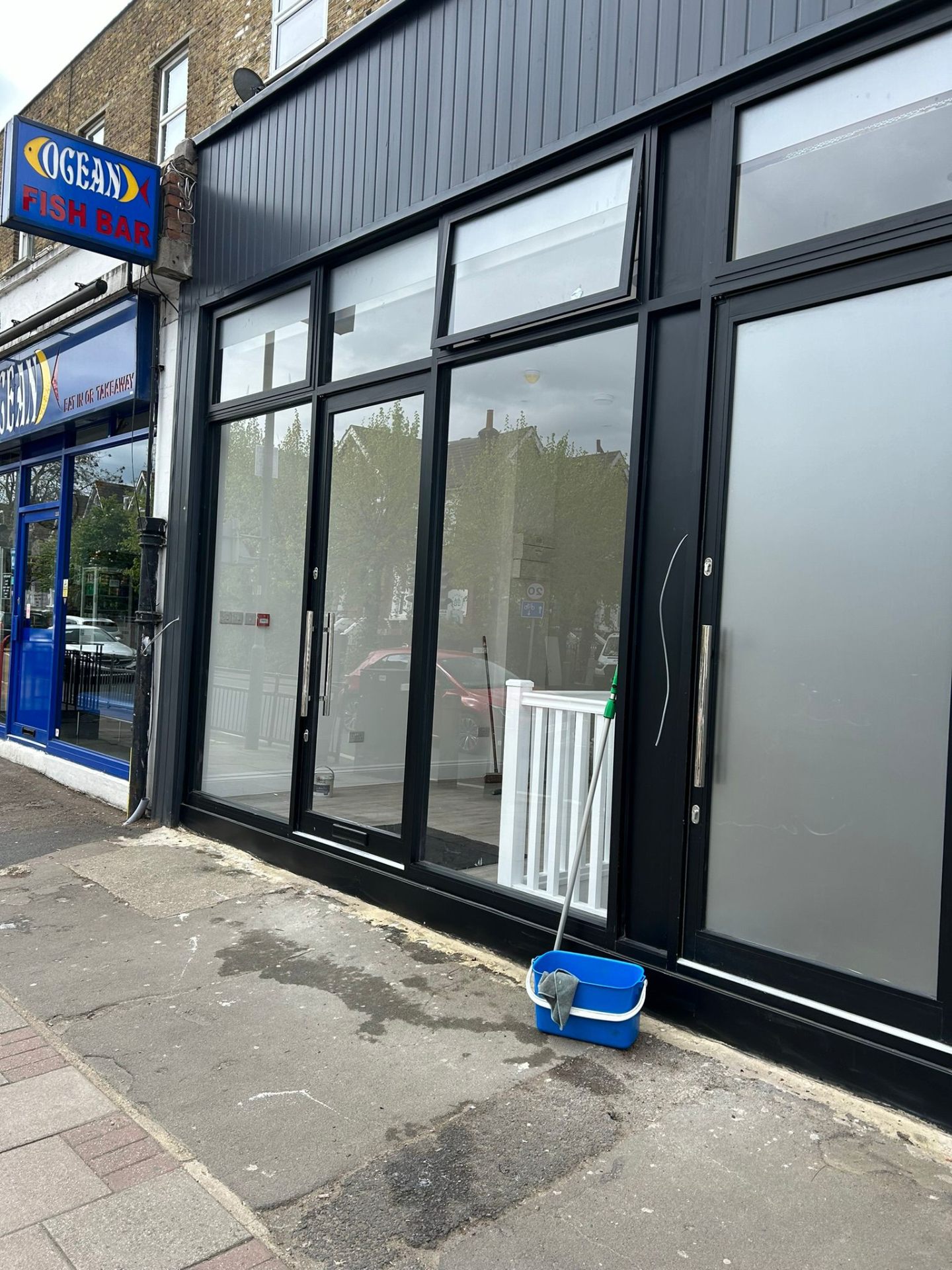 Commercial storefront window cleaning with professional equipment