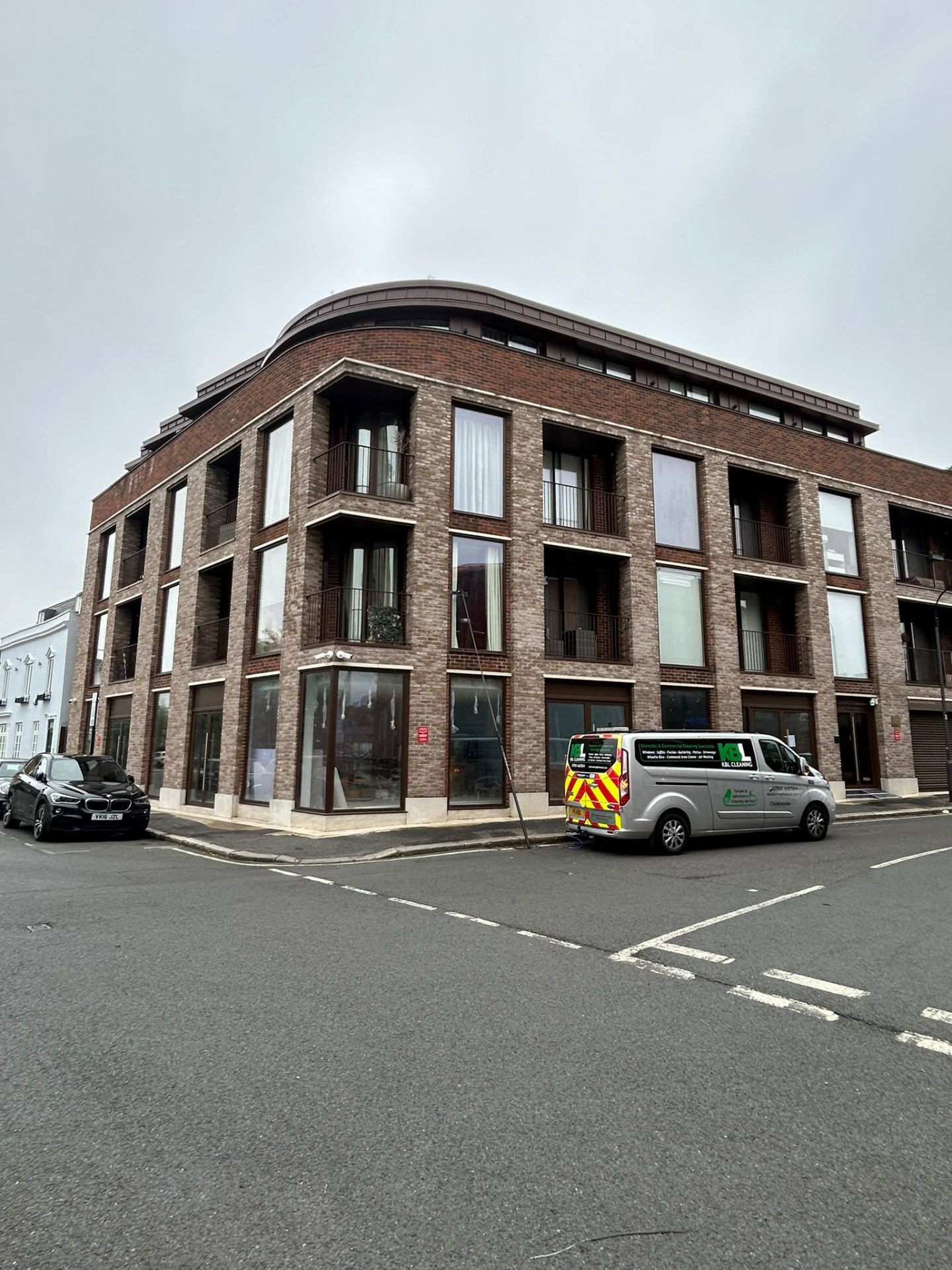 Professional window cleaning service at modern apartment complex